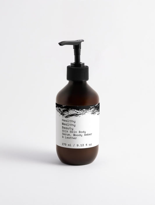 Silk Skin Body Serum in a pump bottle, featuring woody amber and leather scent.