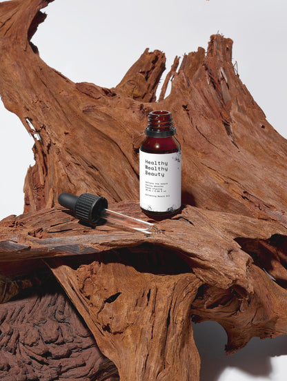 Softening Beard Oil bottle with dropper on natural wood background.