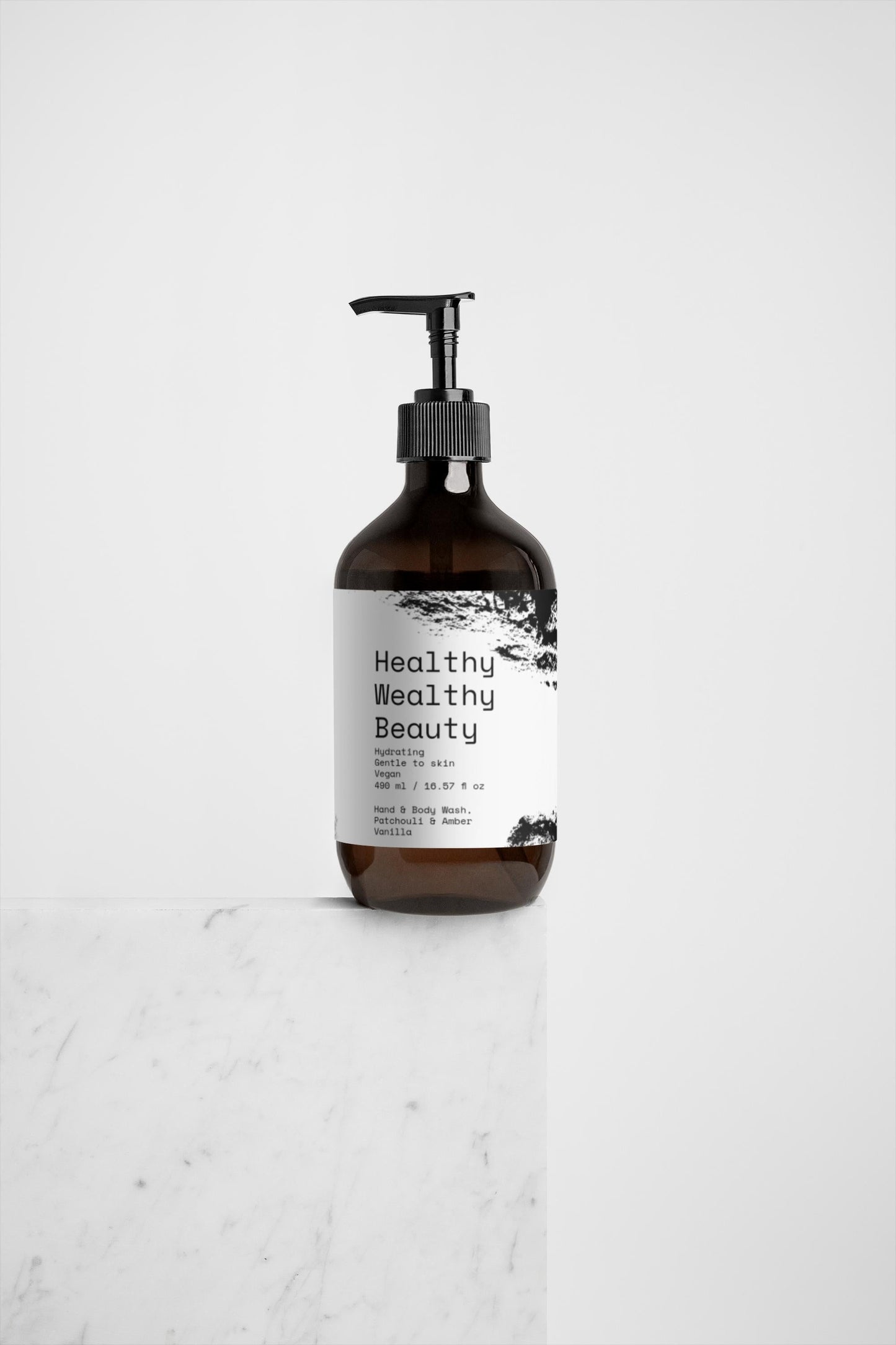 Hand and body wash with patchouli, amber, and vanilla on a marble surface; ideal for spas and wellness.