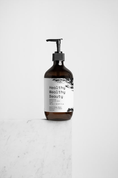 Hand and body wash with patchouli, amber, and vanilla on a marble surface; ideal for spas and wellness.