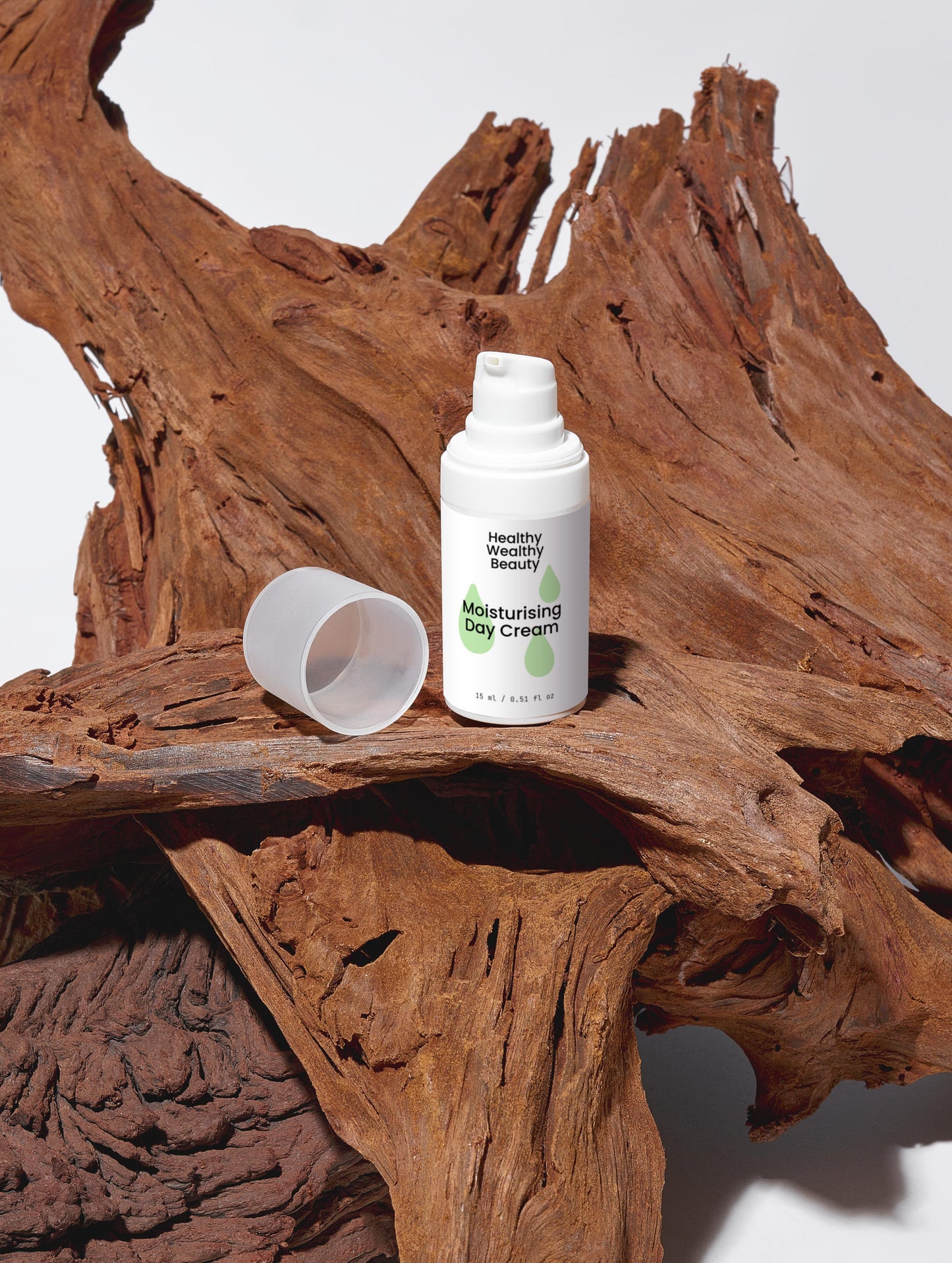 Moisturising Day Cream with hyaluronic acid and natural extracts on driftwood background.