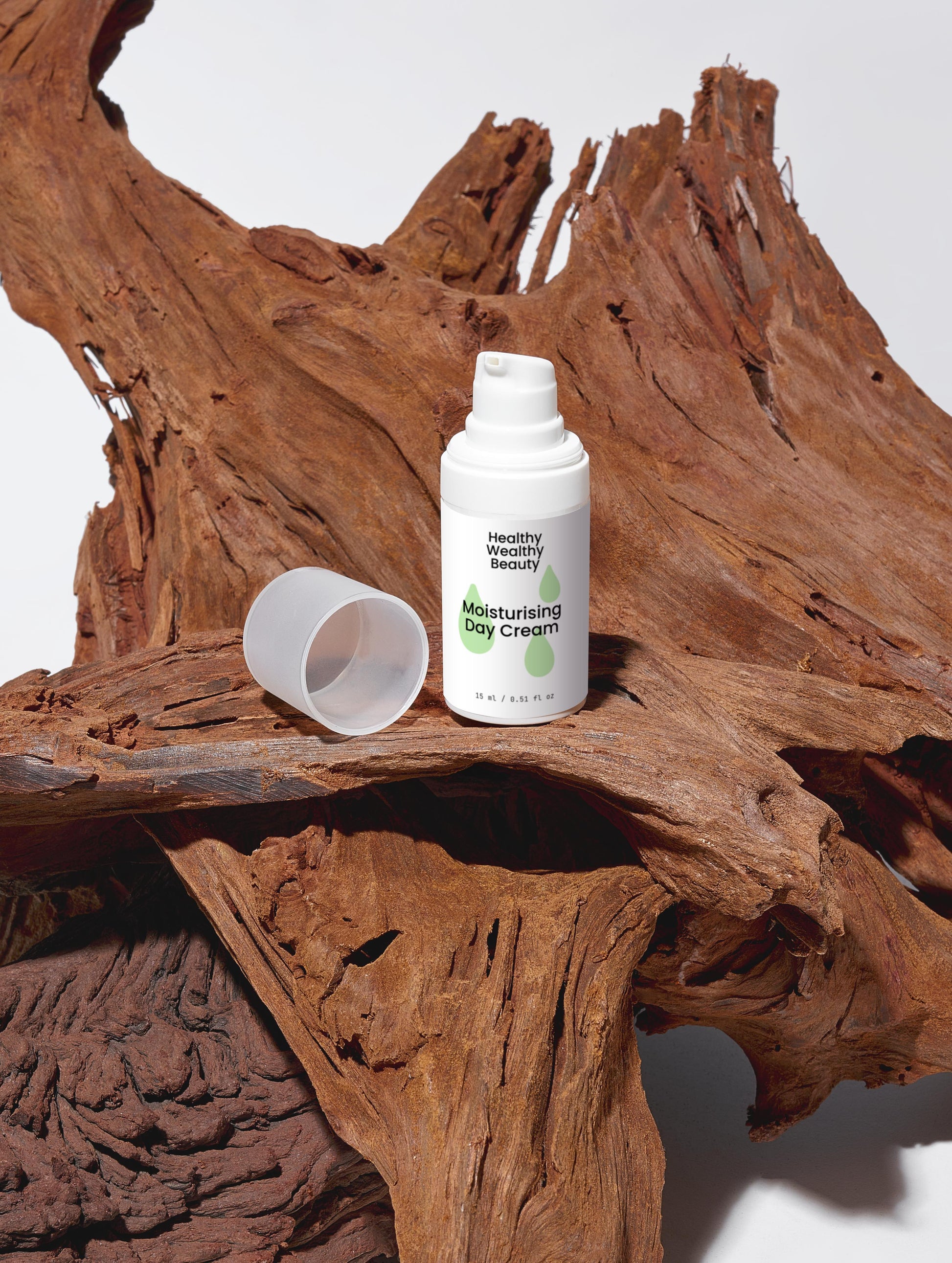 Moisturising Day Cream with hyaluronic acid and natural extracts on driftwood background.