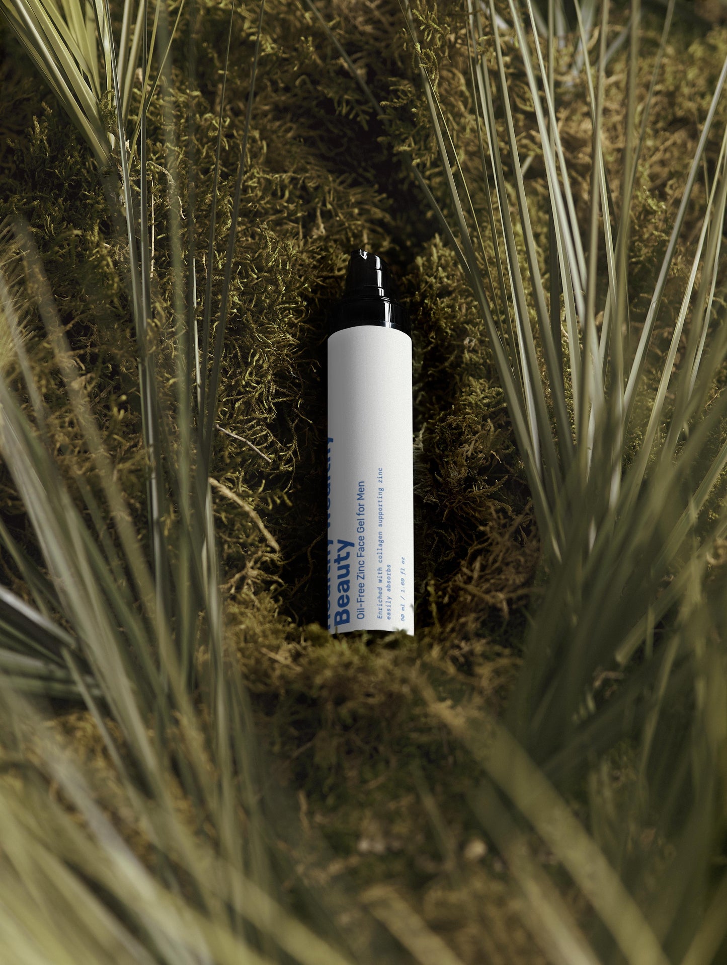 Oil-Free Zinc Face Gel for men, black packaging, surrounded by greenery.